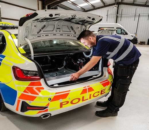 Victory Conversions aftersales support technician working on police car conversion